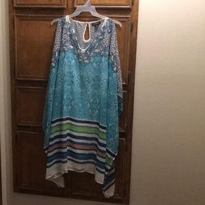 A Turquoise Poncho Dress with jewel detail.